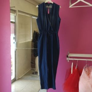 Denim jumpsuit, very cute and comfortable. Loop closure on back. Size XL